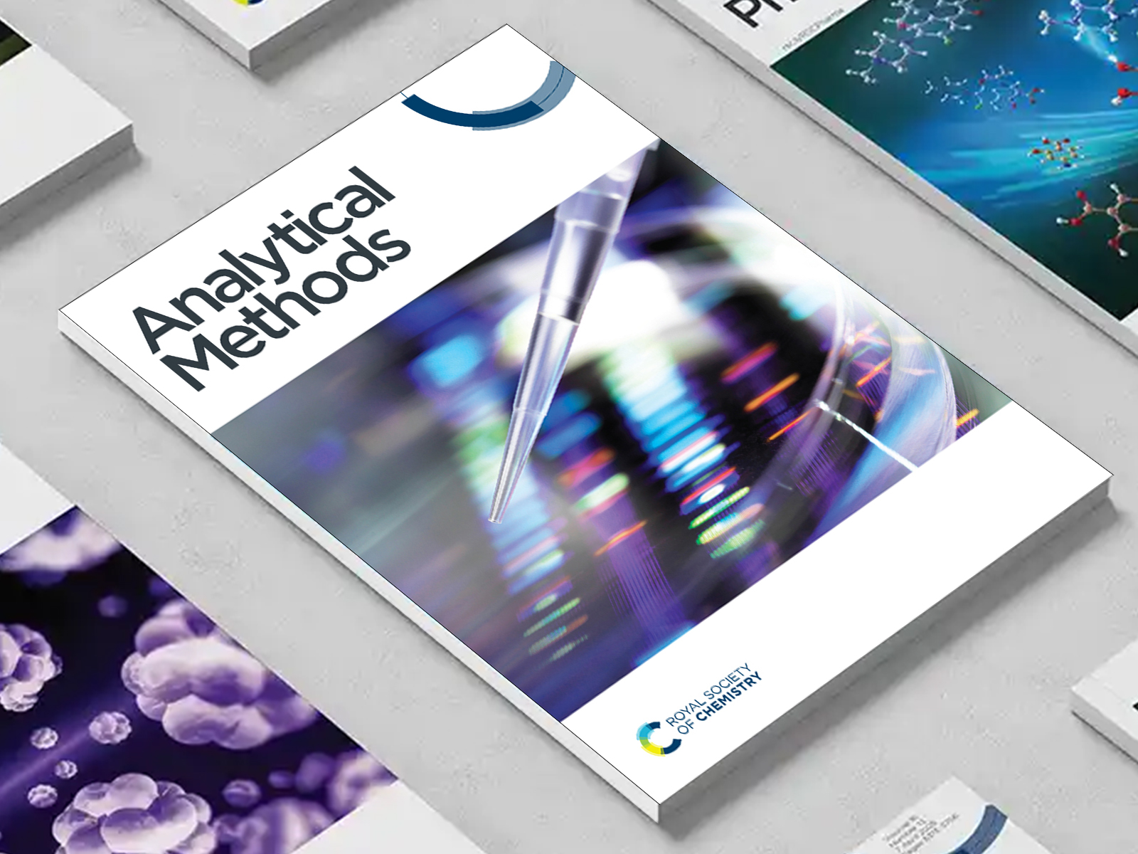 the Analytical Methods journal among a group of other journals on a desk
