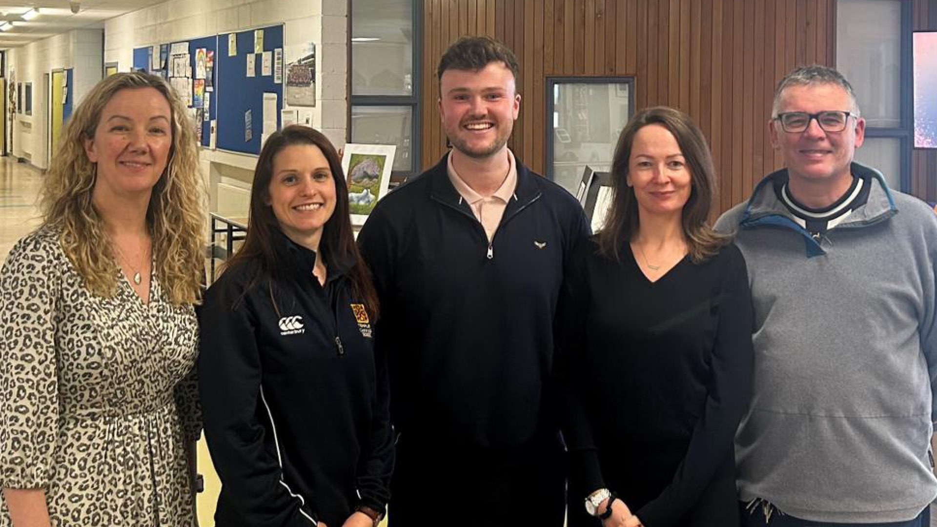 Conor Eivers with colleagues smiling to camera