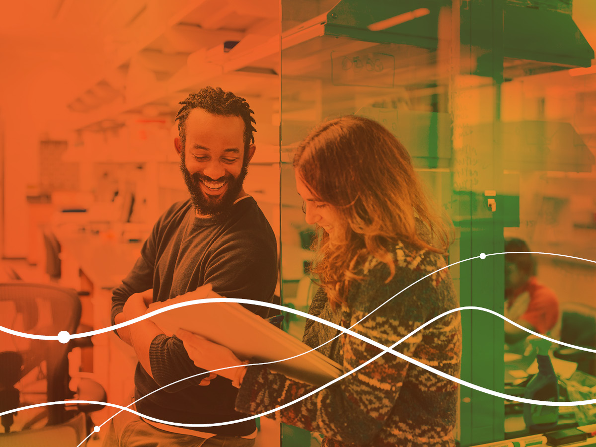 two people standing together laughing