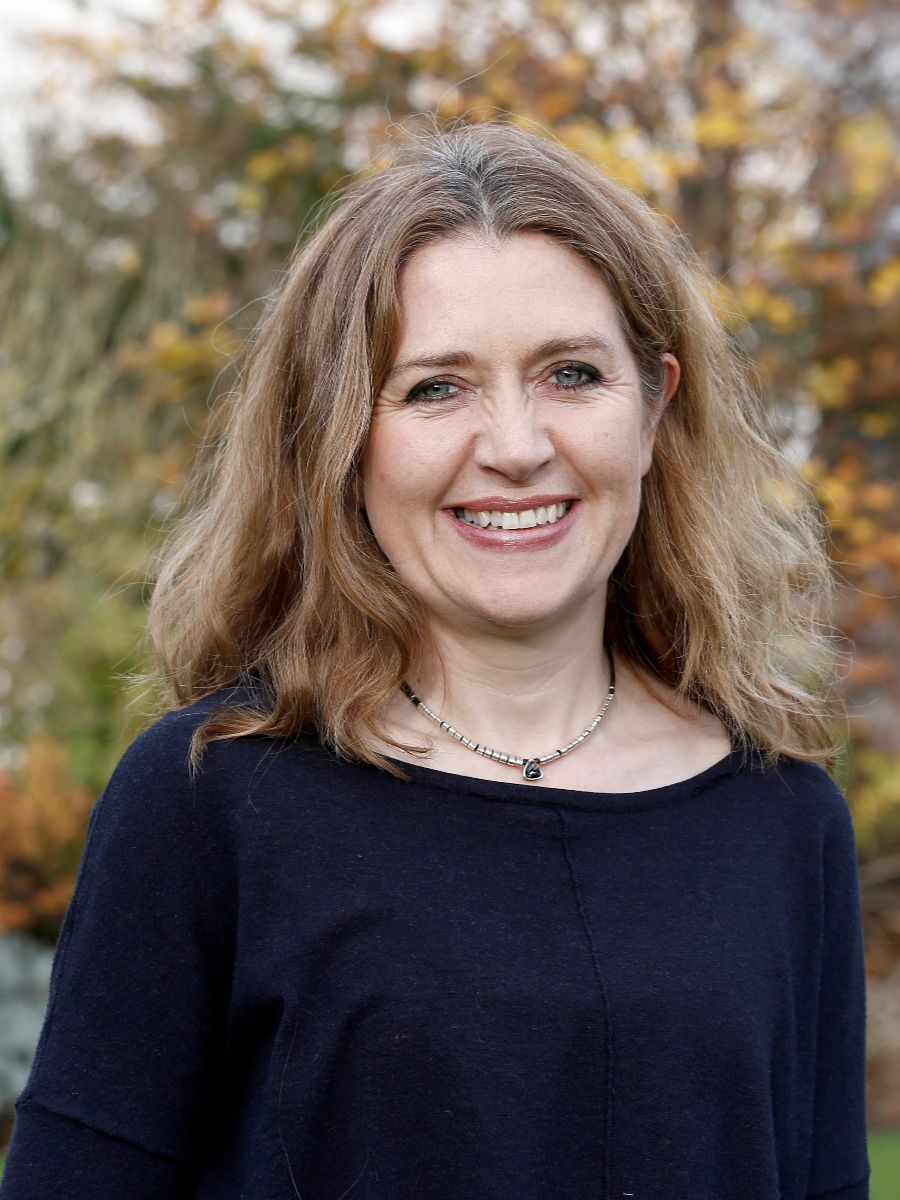Elise Cartmell smiling to camera in blue top