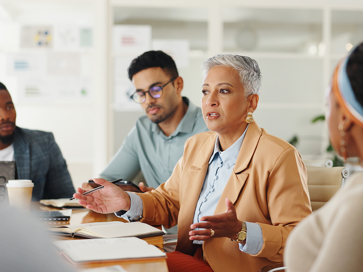 Senior woman and business people in meeting