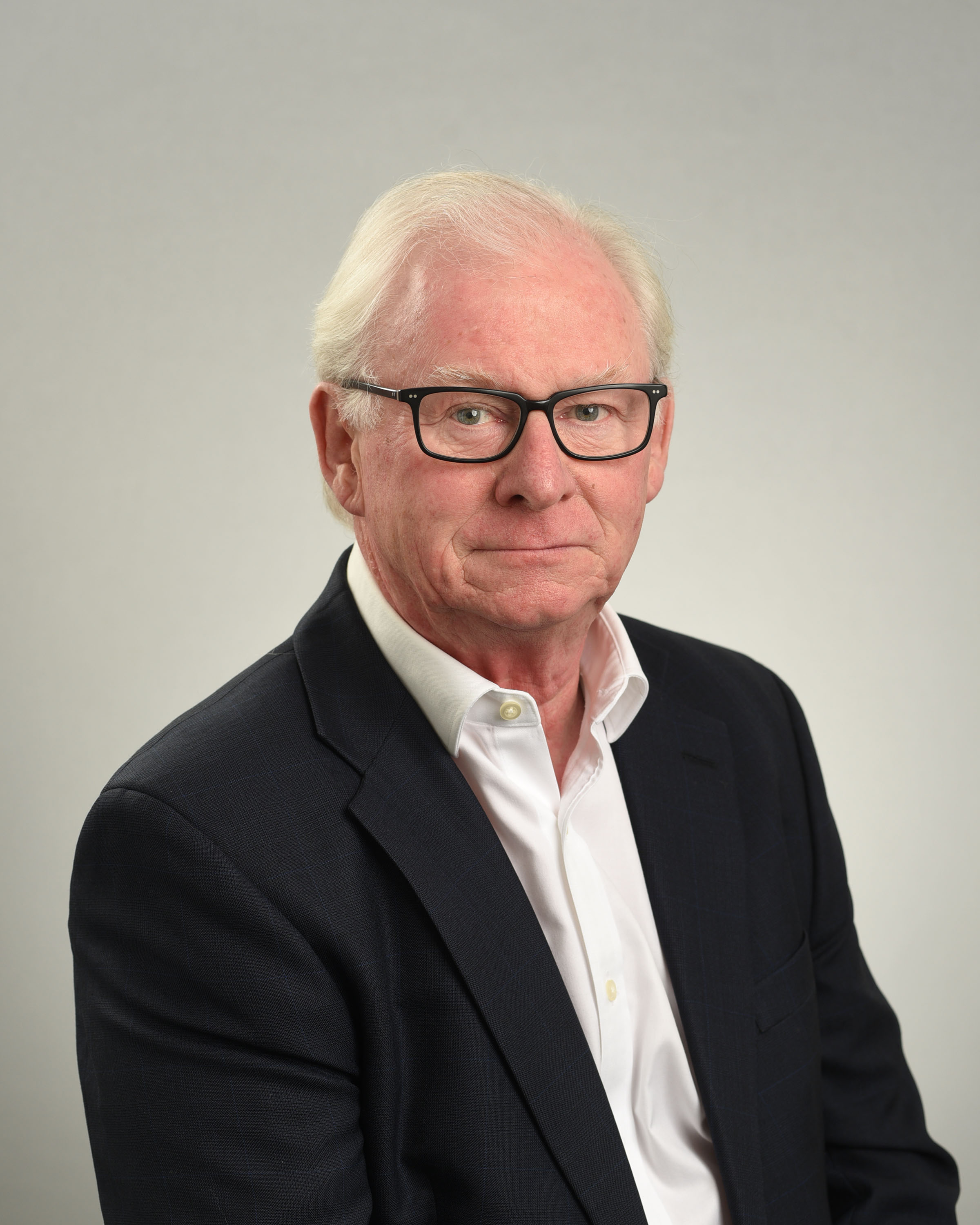A portrait photo of David Morgan in a black suit and white shirt