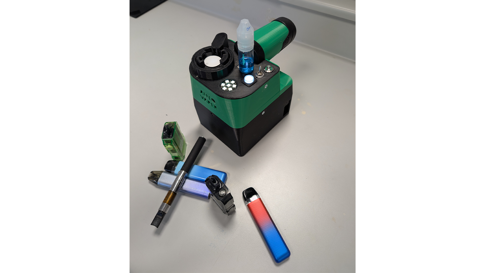 A green and black drug detecting device created by Harm Reduction