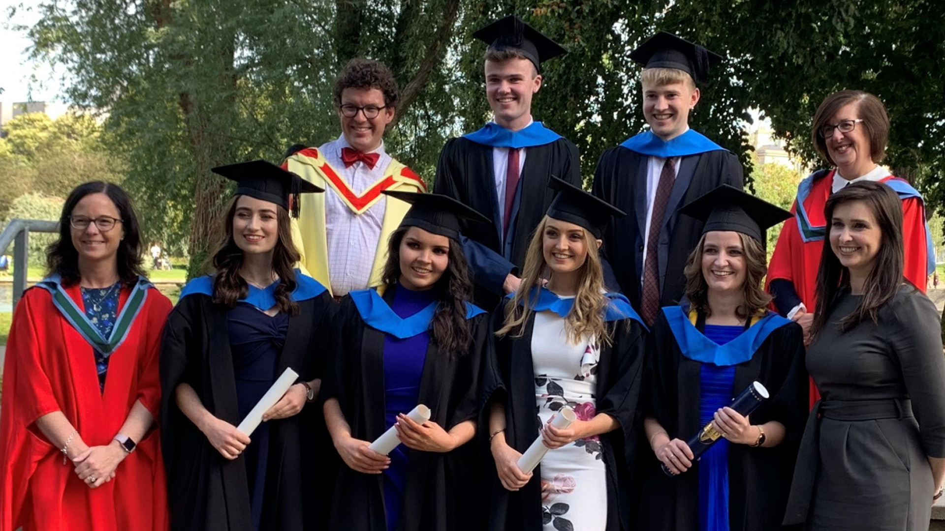Conor Eivers in graduation gown with others who graduated with him