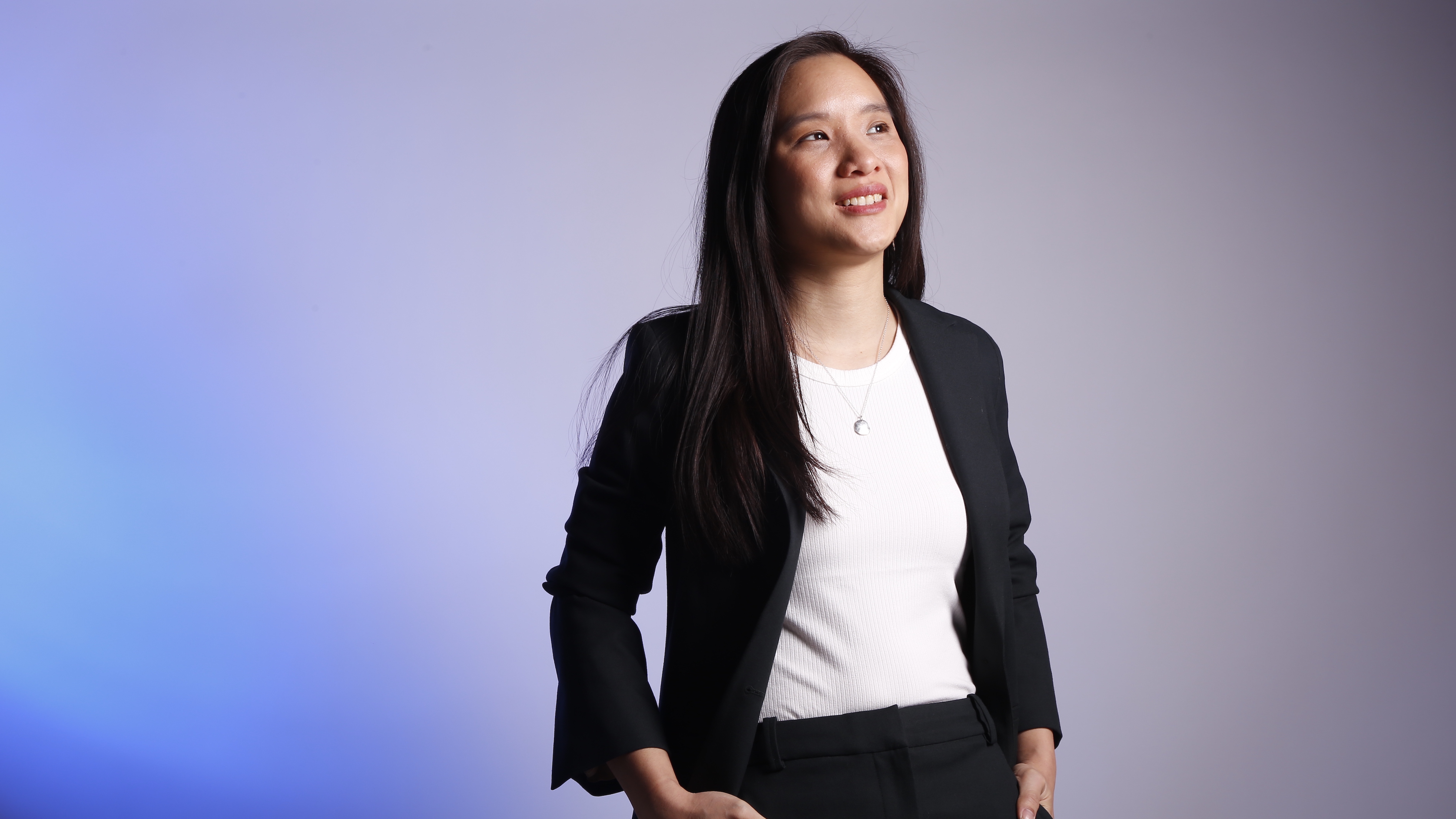 Dr Florence Huynh in a suit, smiling