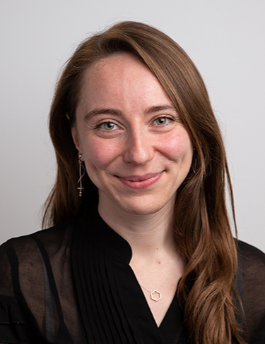 Headshot of Kathryn Gempf smiling at the camera, wearing a black top.