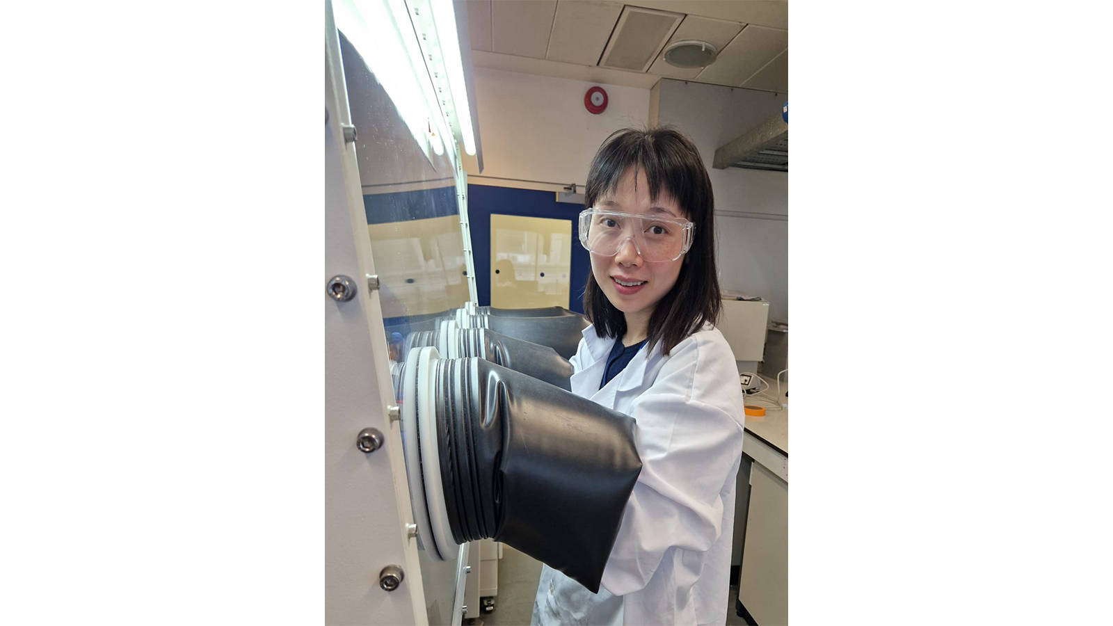 a woman wearing goggles and white coat
