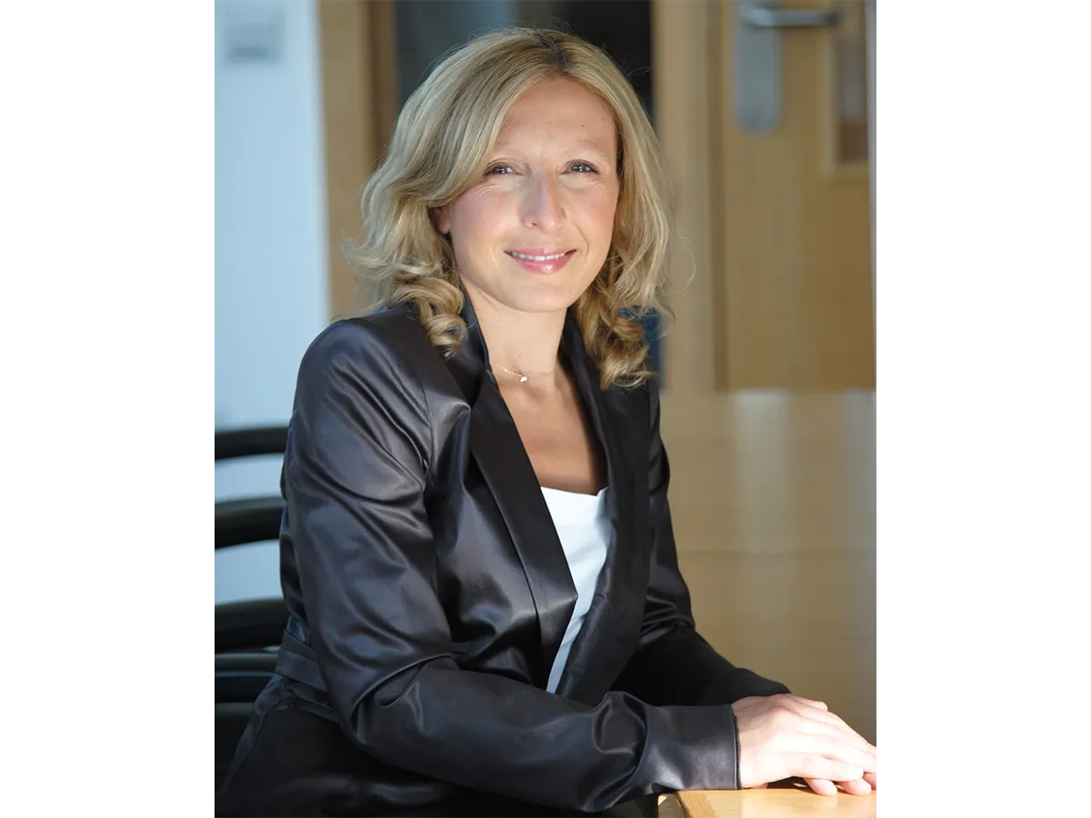 Professor Valeria Nicolosi sitting in black silk suit jacket