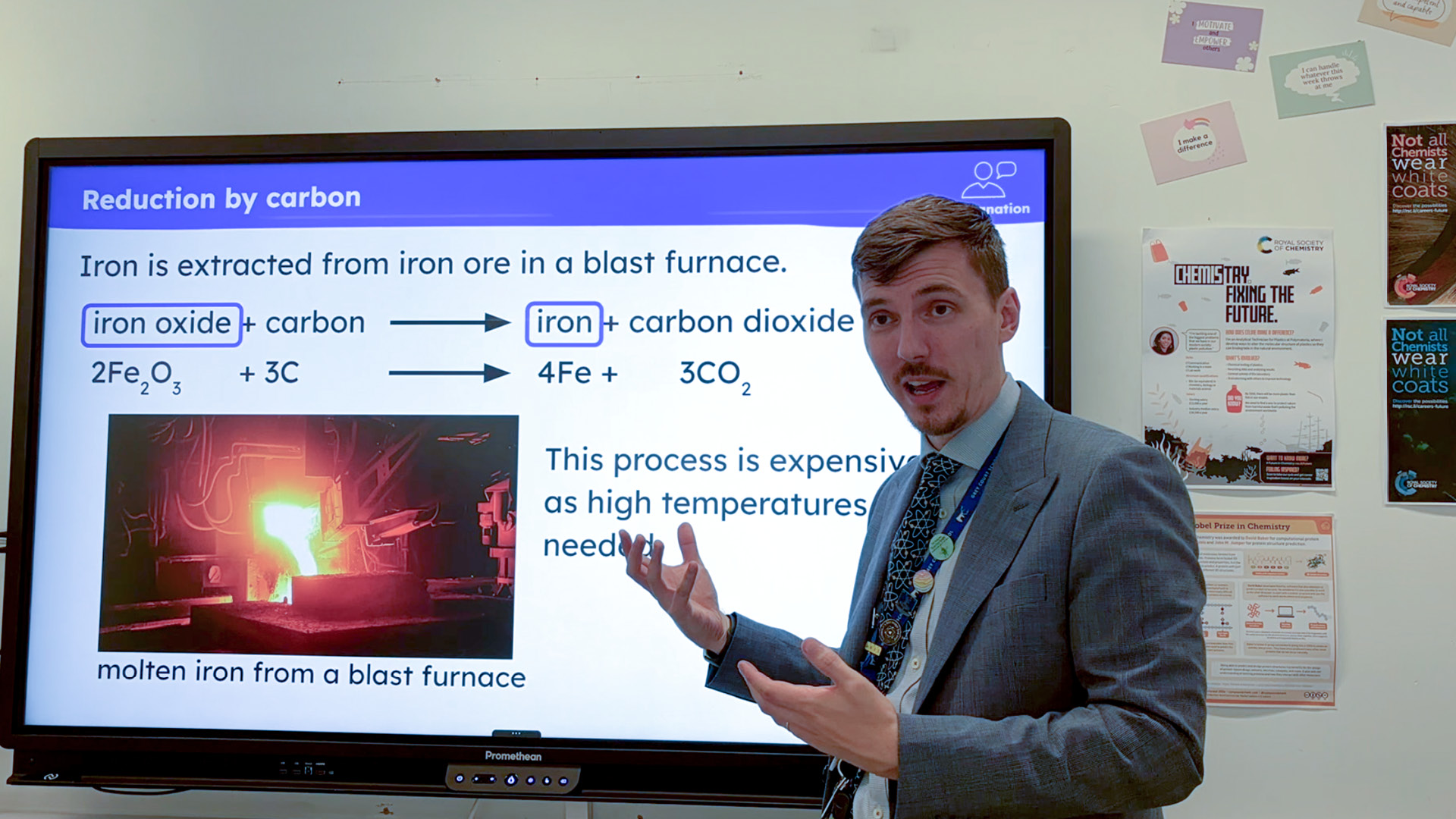 Matthew Gundry in suit and tie lecturing using white board