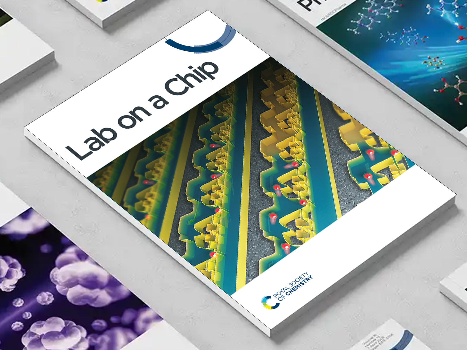 the Lab on a Chip journal among a group of other journals on a desk