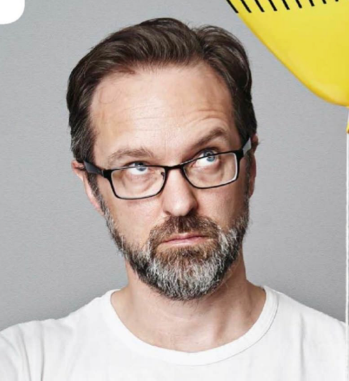 a man with glasses and beard looking up