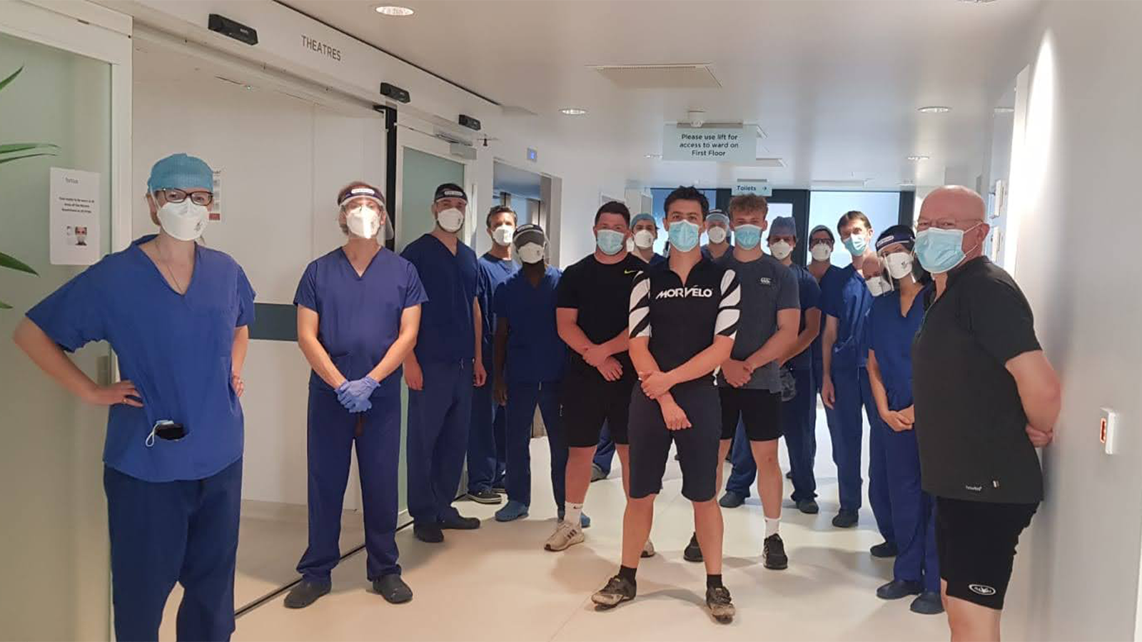 The PERFORM COVID-19 Team wearing face masks in lab corridor