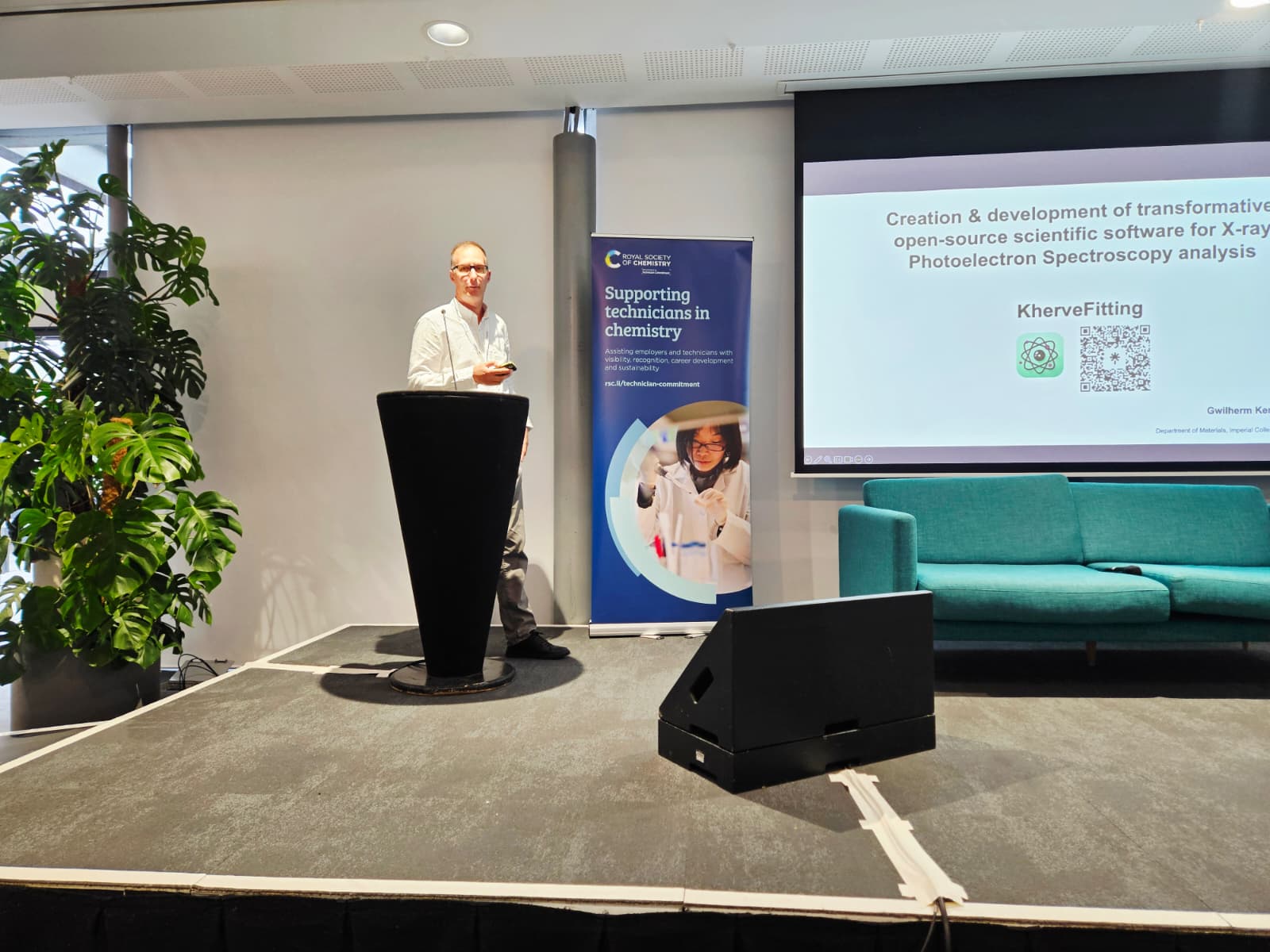 Dr Gwilherm Kerherve standing on a podium