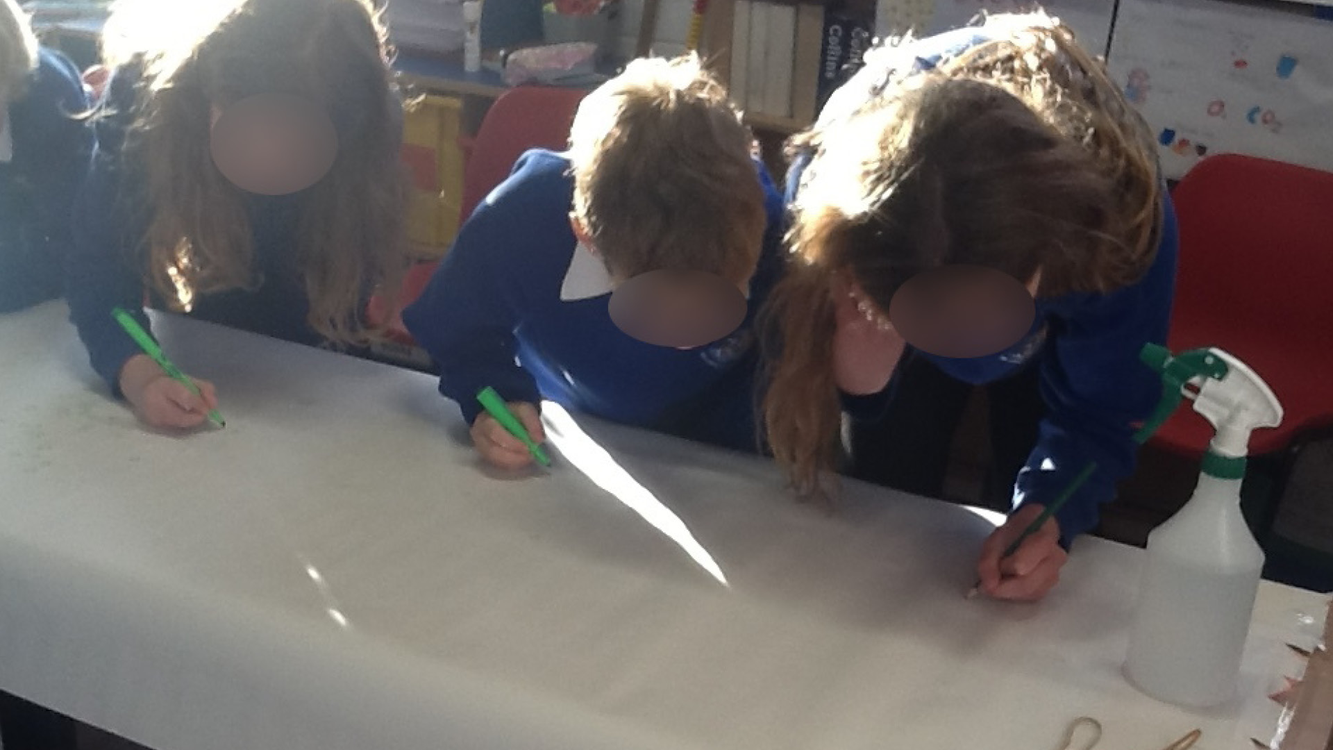 A group of school children working together in a classroom setting