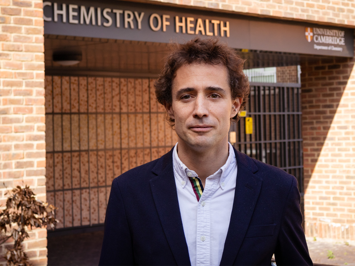 Dr Pietro Sormanni standing outside of a building face to camera, wearing open shirt and suit