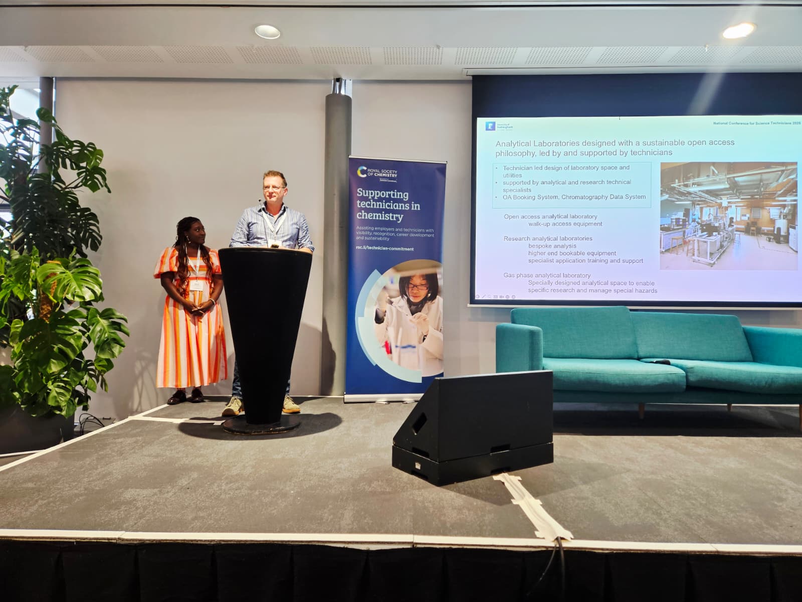 A man and a woman from the GSK Carbon Neutral Laboratories for Sustainable Chemistry team at Nottingham University deliver a presentation