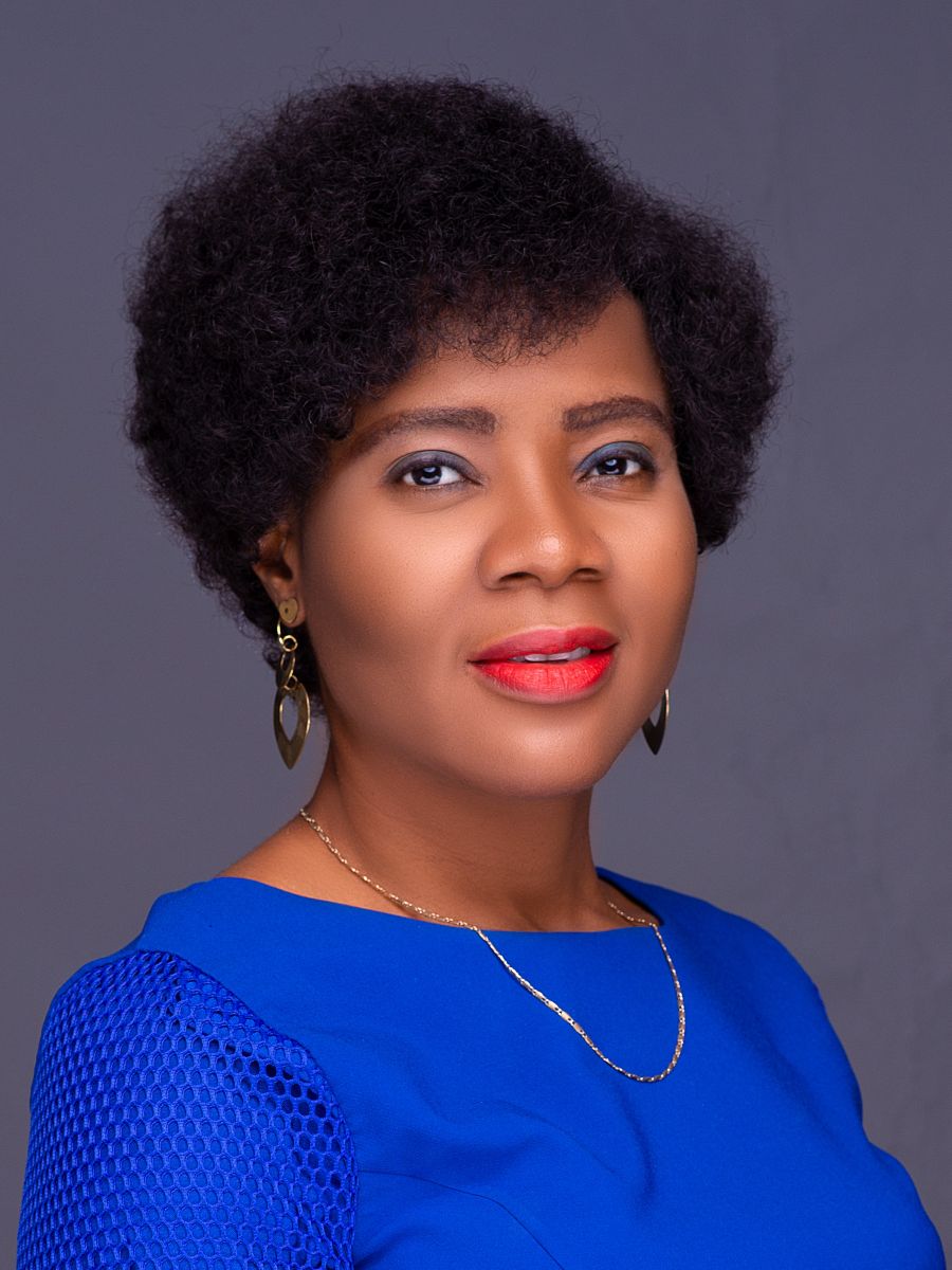 Cynthia Ibeto smiling to camera in royal blue blouse