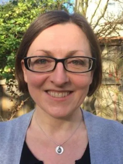 Dr Jennifer Kingston wearing glasses and smiling for the camera