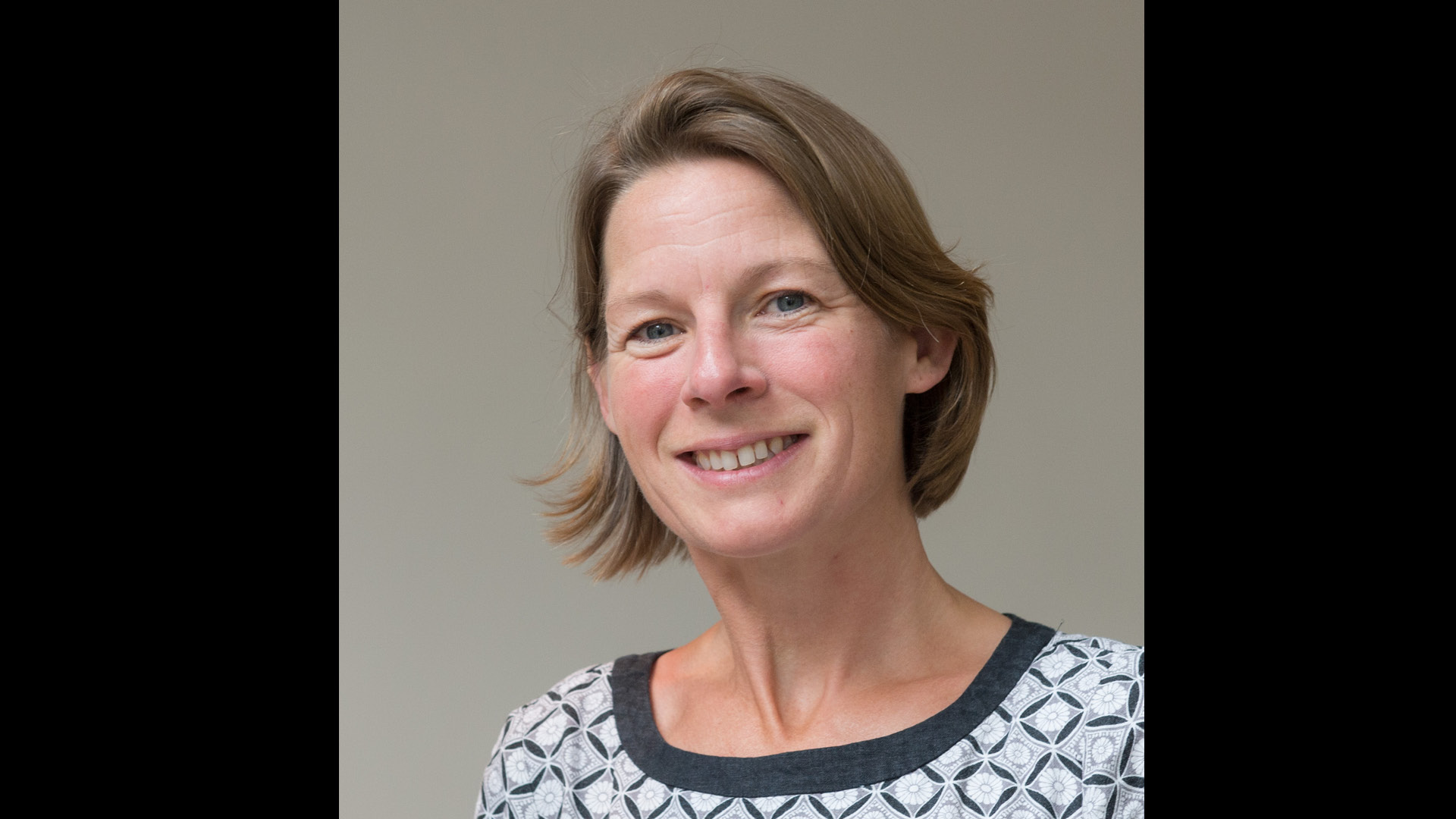 Team member Katharine Pemberton Did You Know smiling to camera in blue patterned top