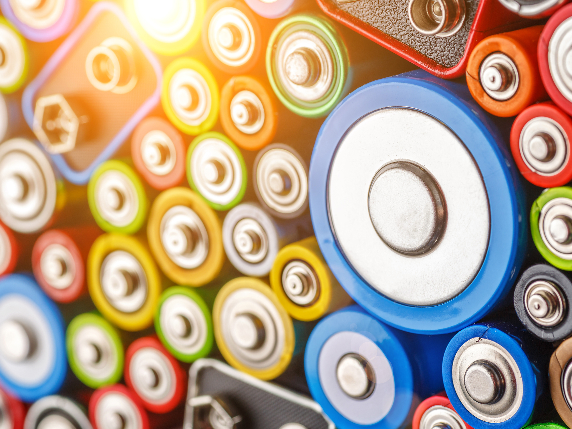 a group of colourful batteries packed tightly together in closeup