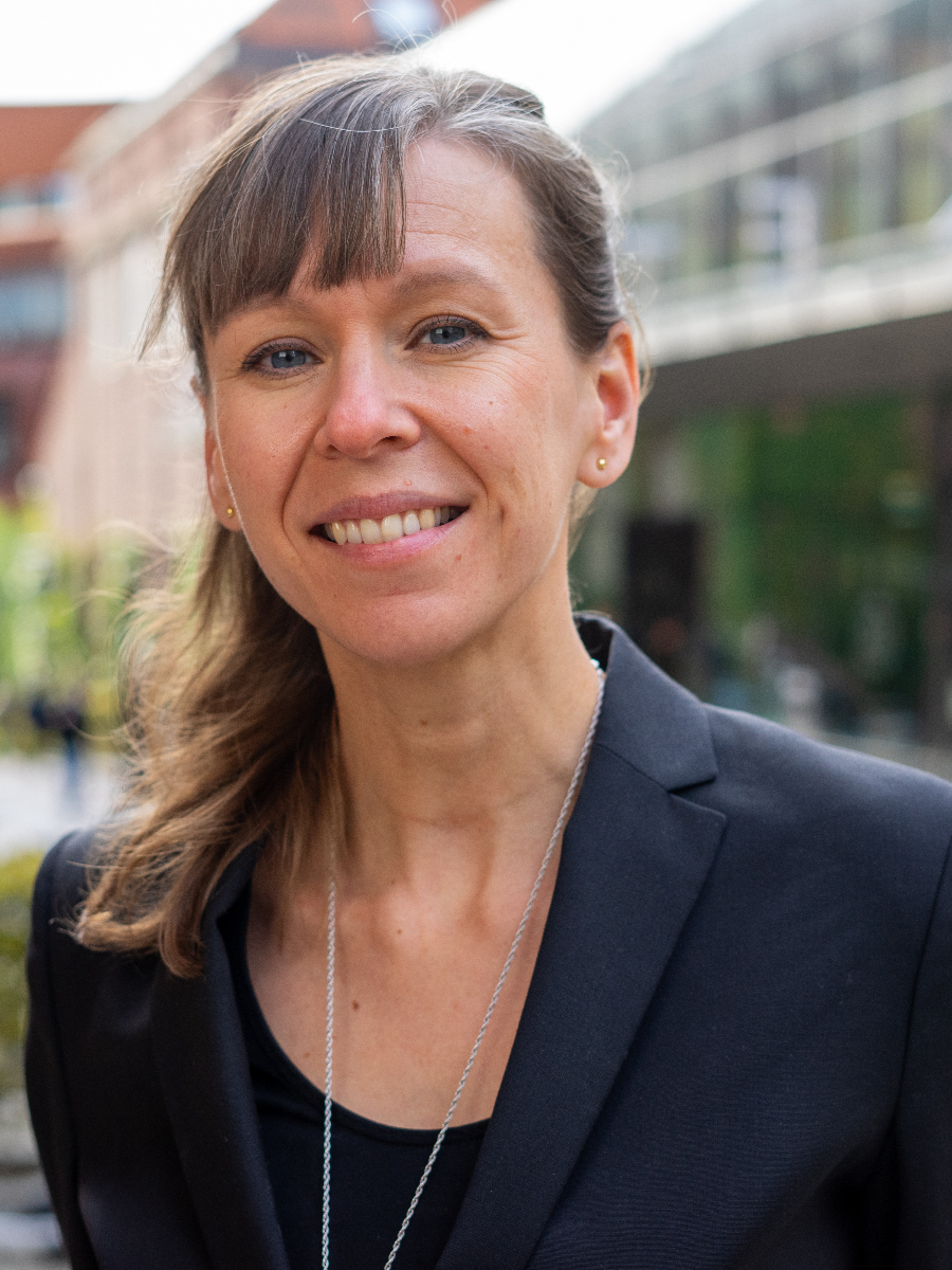 Helena Lundberg smiling to camera wearing suit jacket