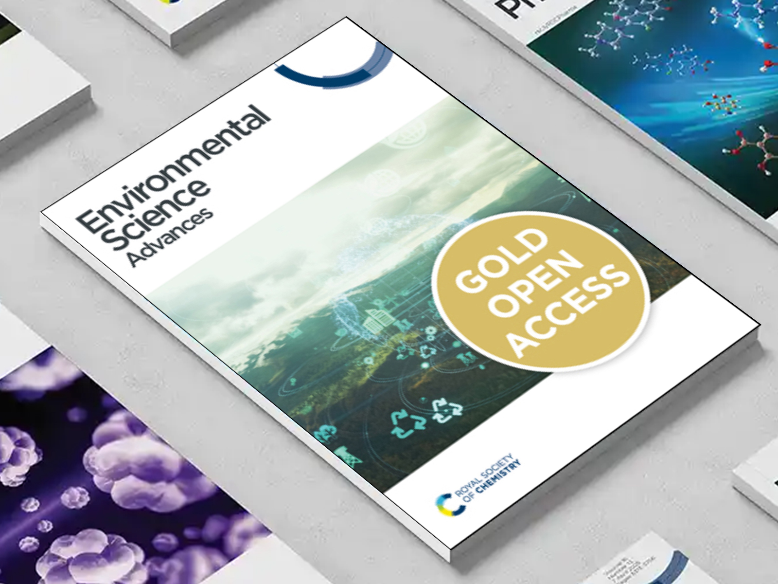 the Environmental Science Advances journal among a group of other journals on a desk