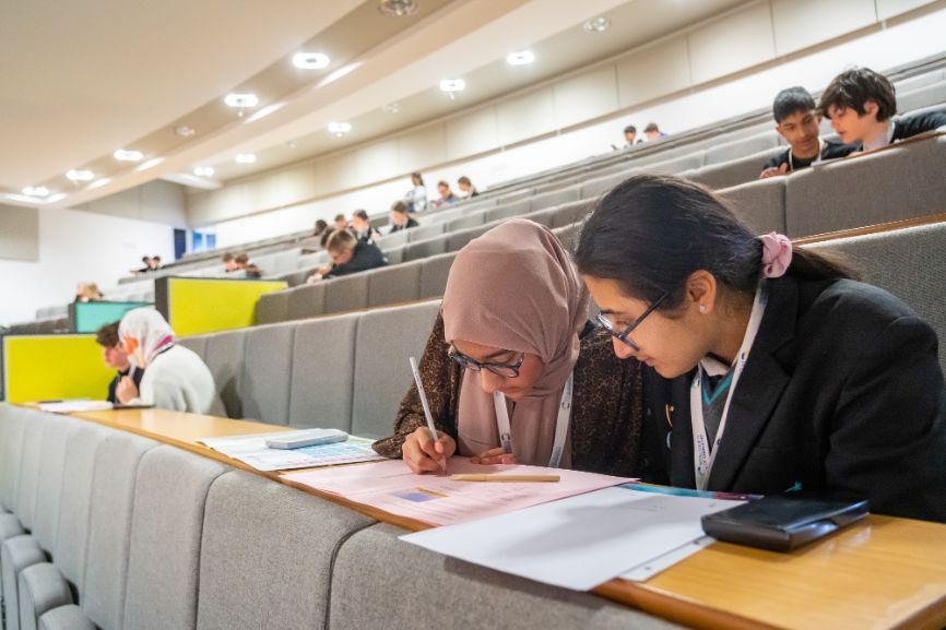 Students work away at a problem in a lecture hall at the University of East London