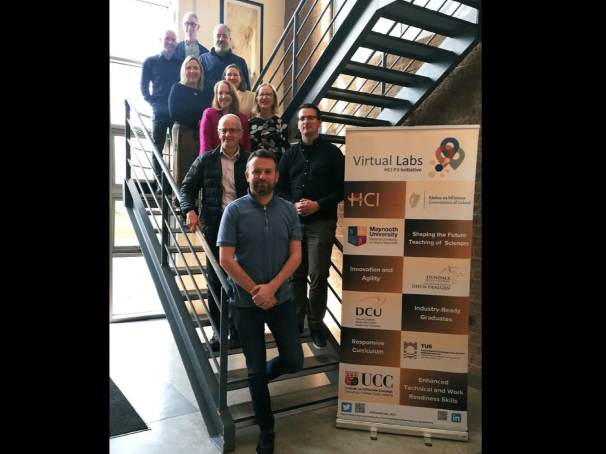 Virtual Labs Team standing on metal staircase