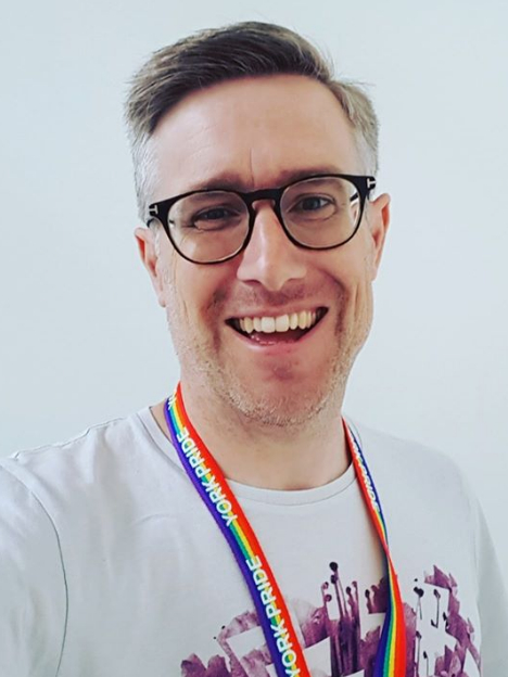 David Smith wearing glasses and a white shirt