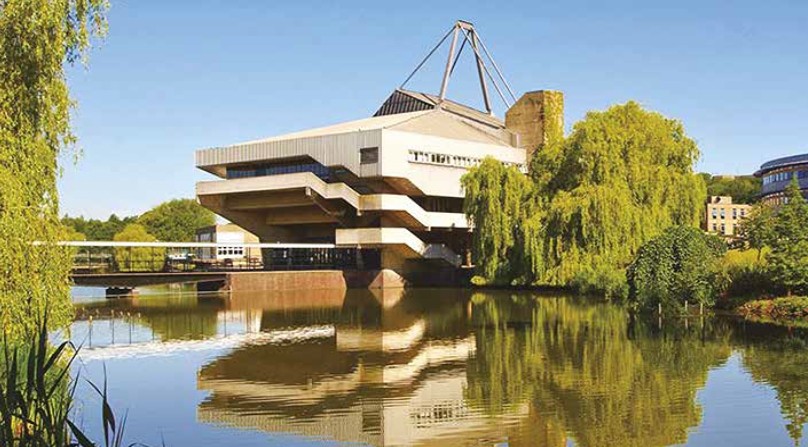 Central Hall at the University of York with campus lake in foreground