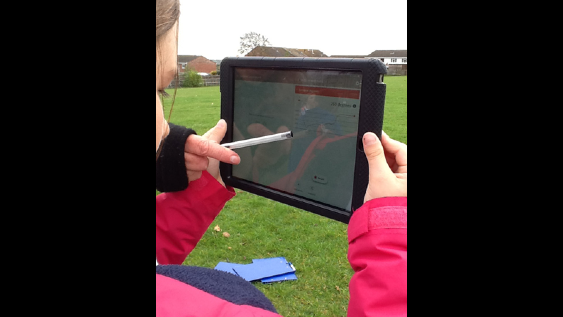 A group of children using a tablet