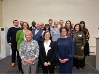 A group photograph of the RSC Food Group Committee standing together indoors against a plain, light-colored wall.