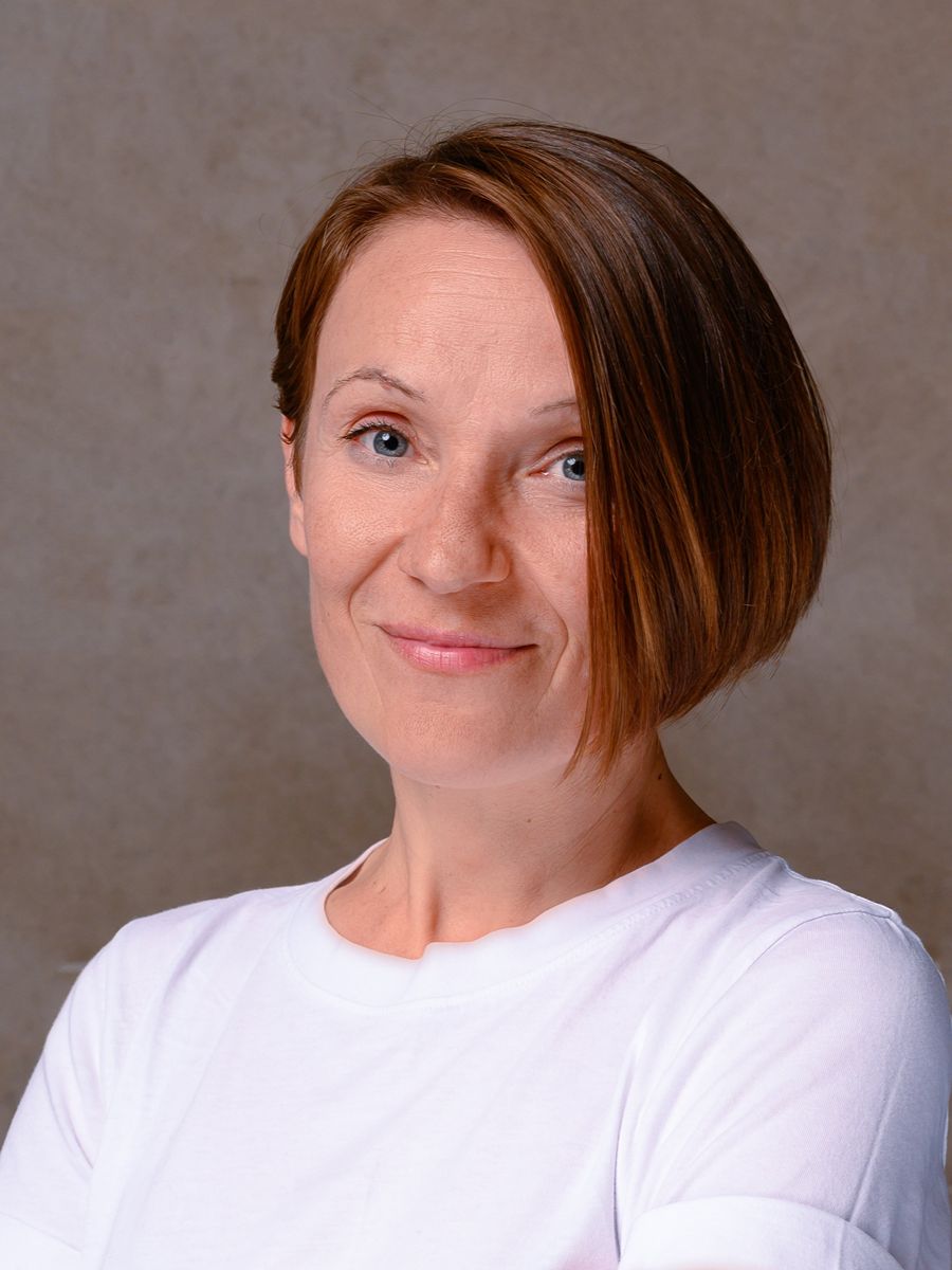 Anna Rulka smiling to camera in white T-shirt