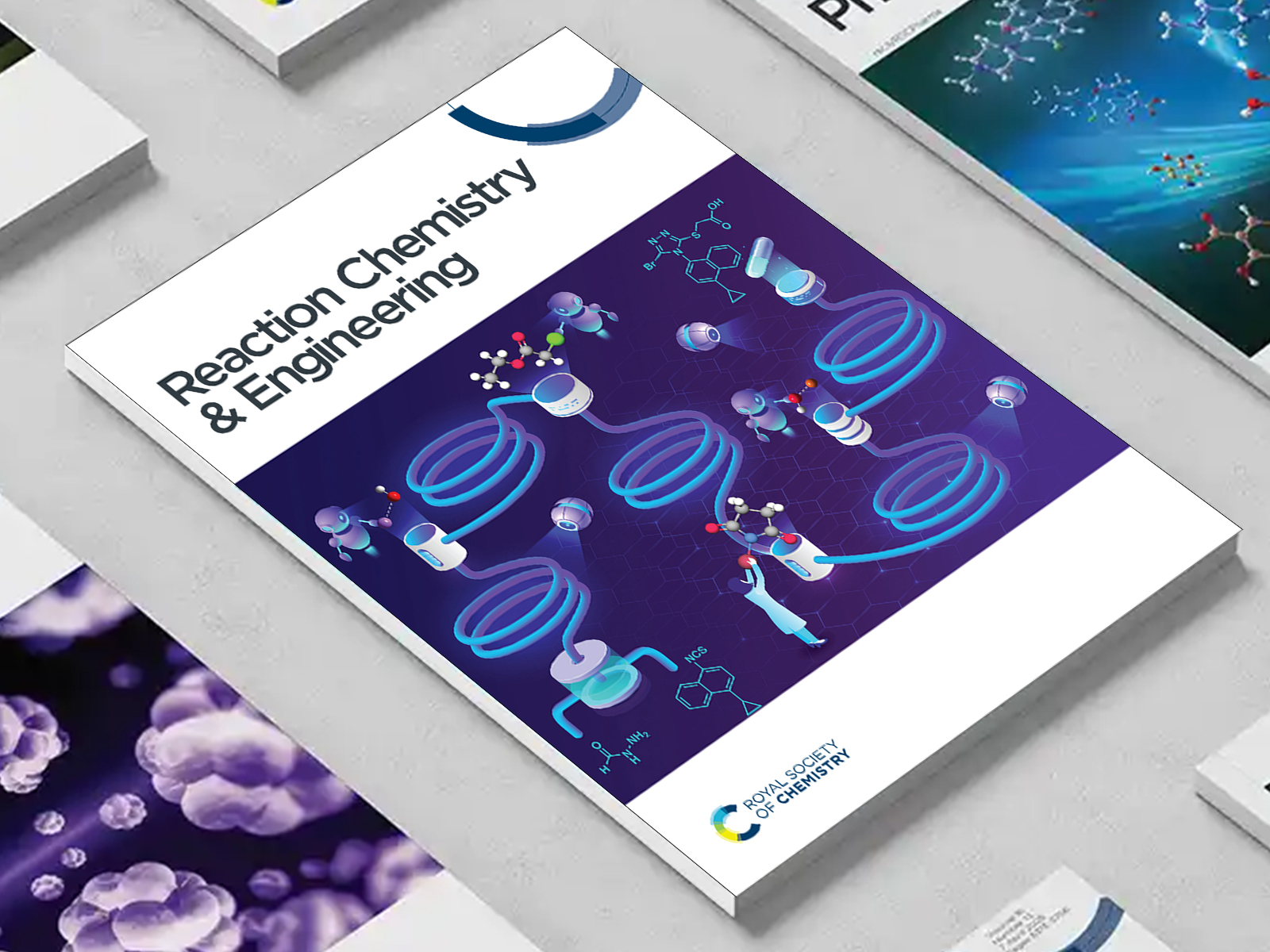 the Reaction Chemistry & Engineering journal among a group of other journals on a desk