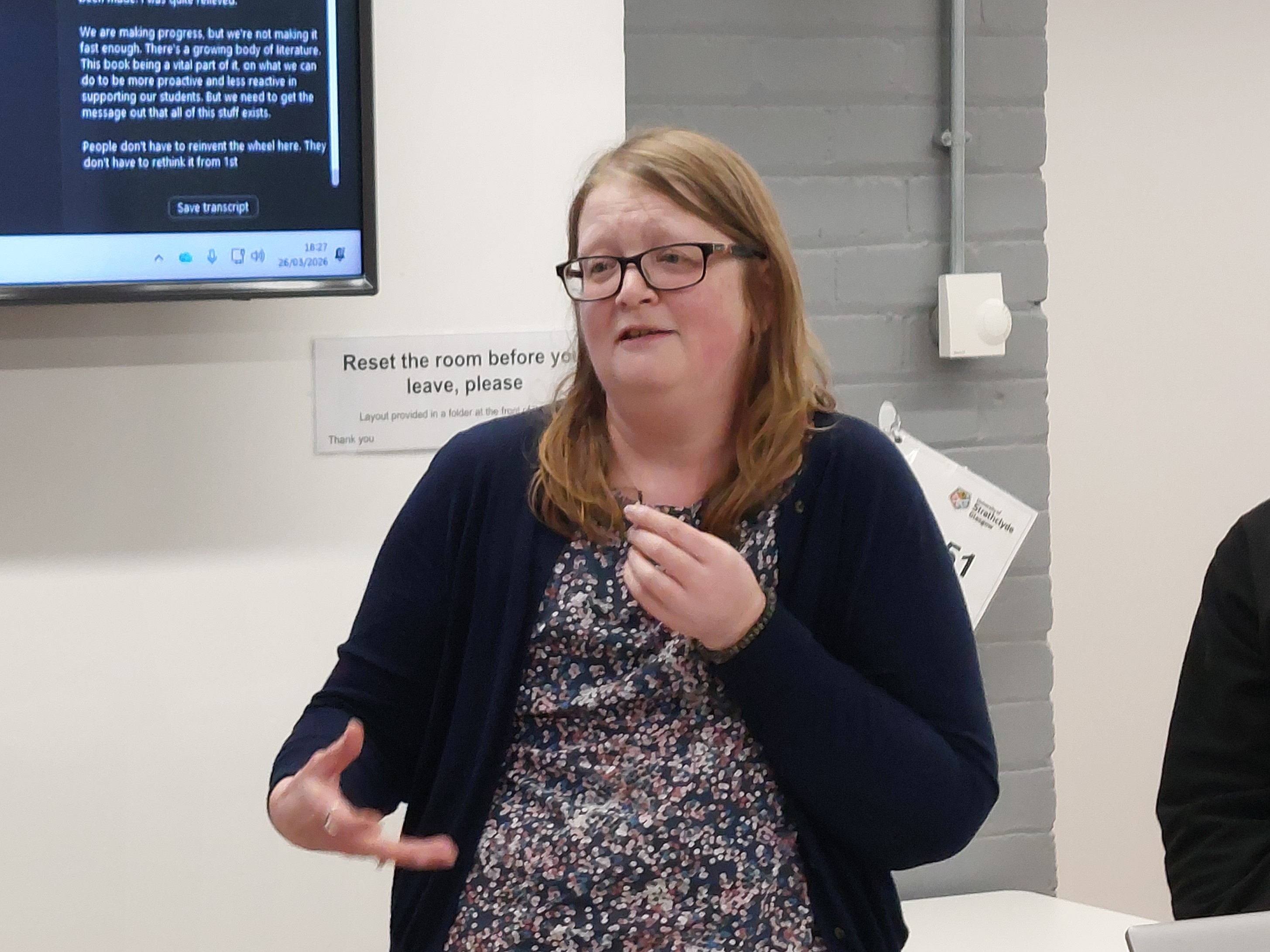 Dr Katherine Haxton presents to a group of attendees out of shot