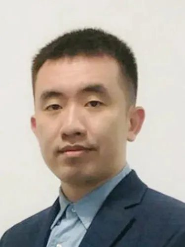 Zheng Li Headshot of Zheng Li wearing blue short and dark blazer