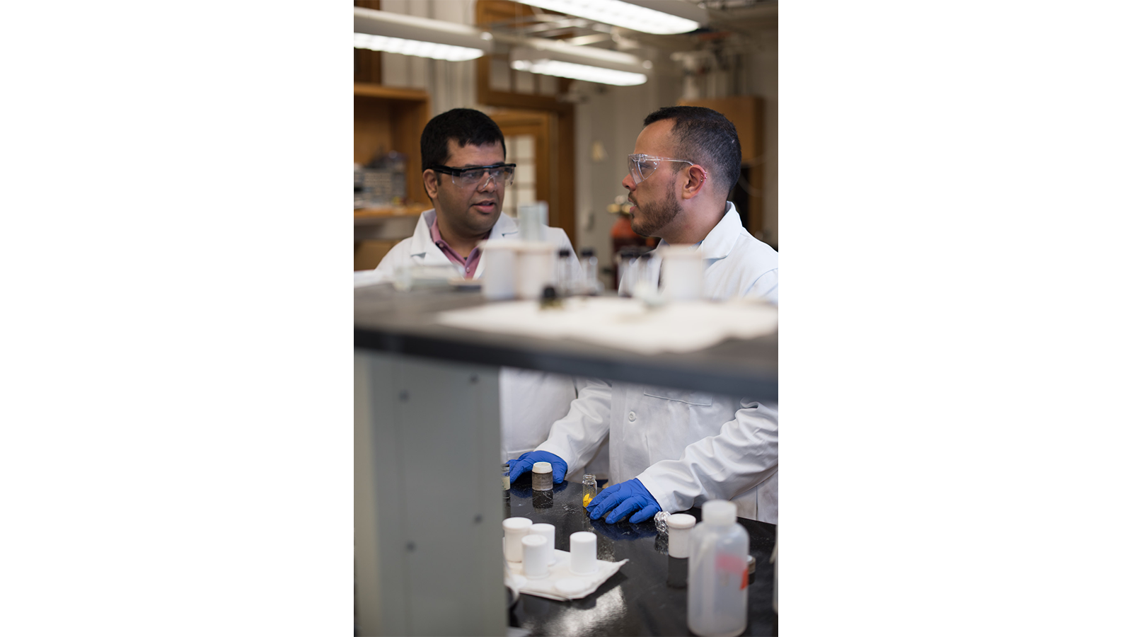 Professor Sarbajit Banerjee's team in white coats and gloves in a lab