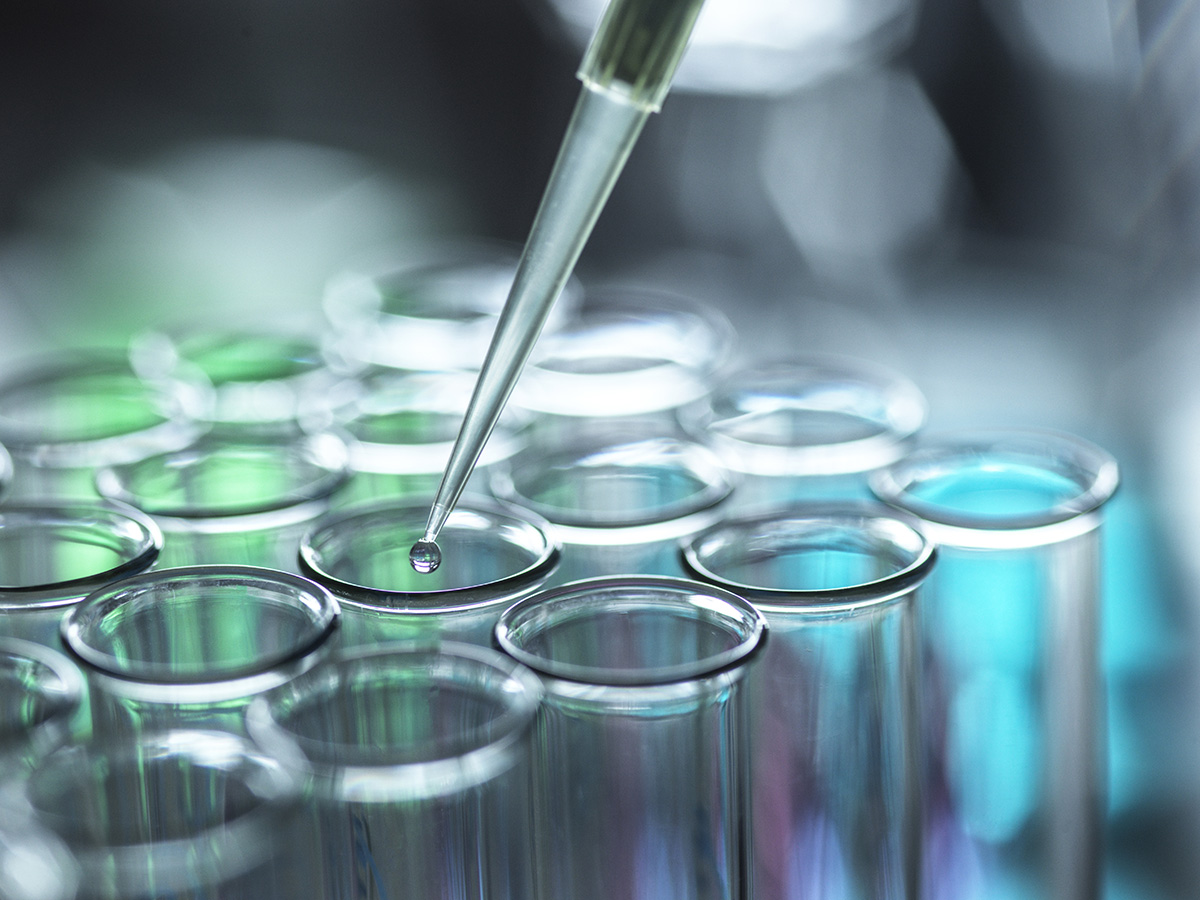 Micropipette dropping liquid into test tubes