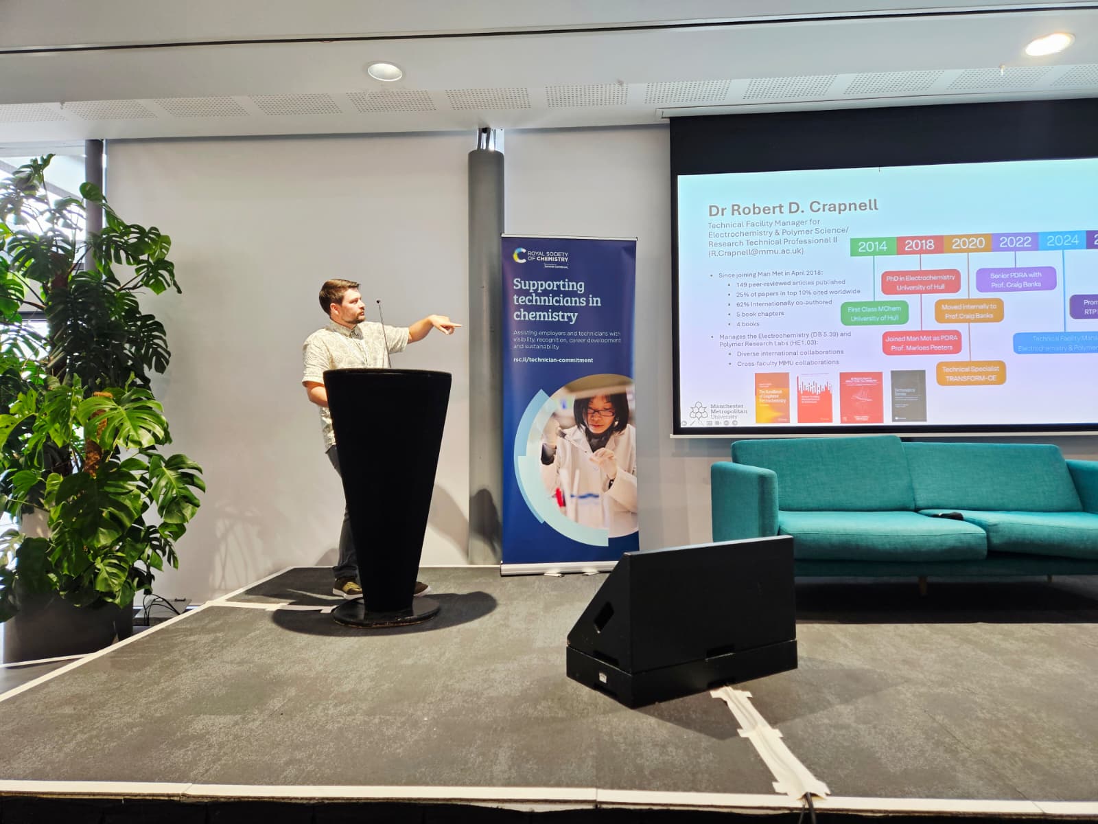 Dr Robert Crapnell, a research technical professional at Manchester Metropolitan University, standing in front of a podium giving a presentation