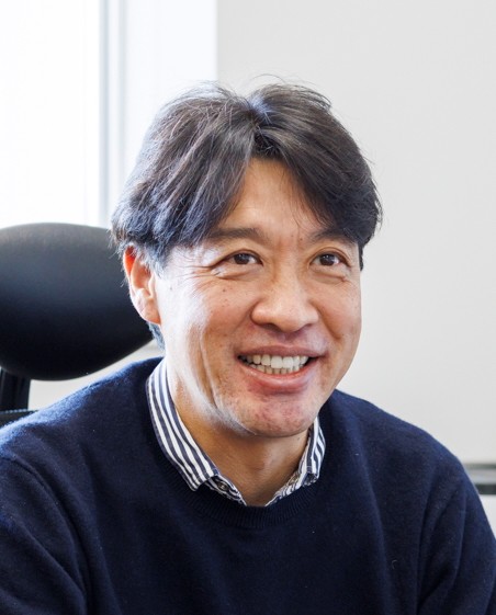 a man sitting in a chair smiling
