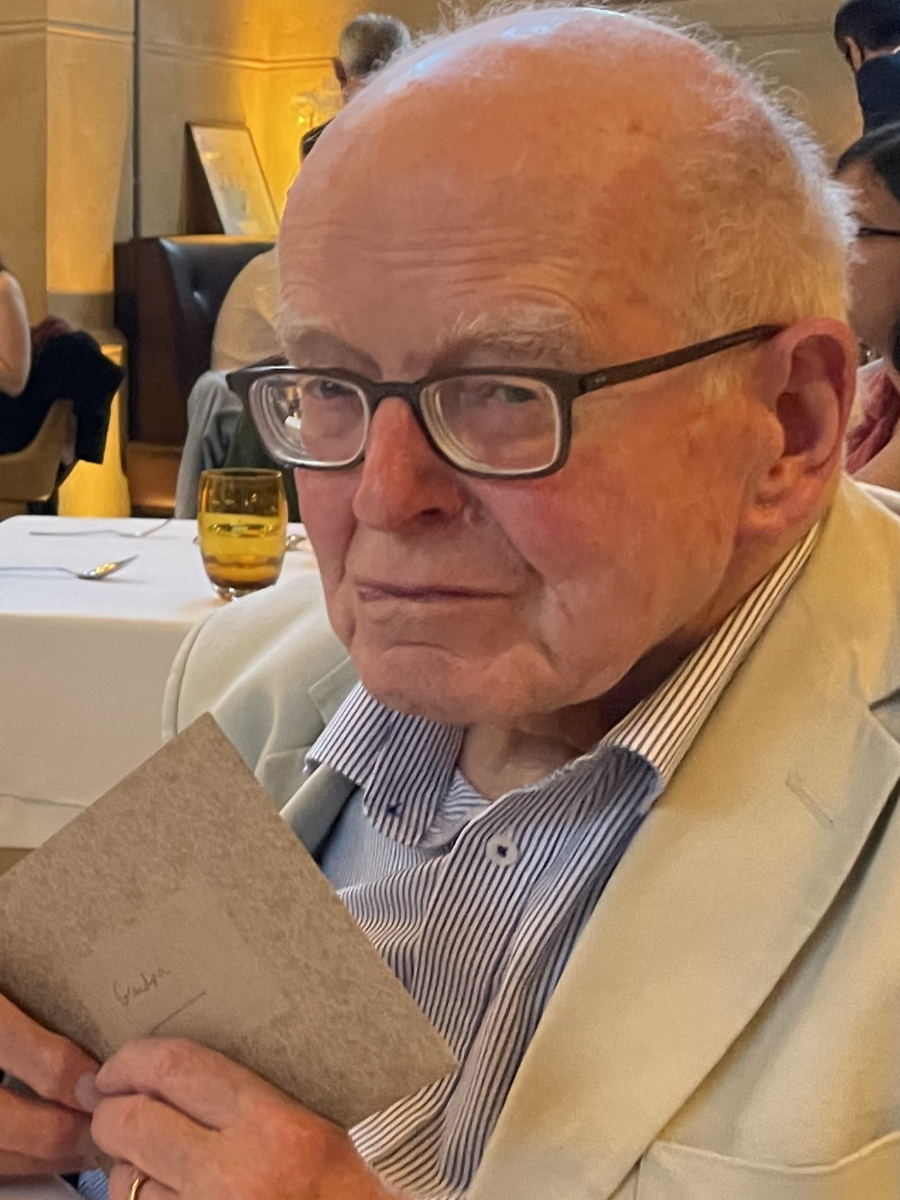 David Feakins wearing shirt and cream jacket and glasses, in restaurant surroundings
