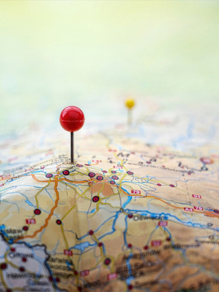 Pins on a map with raised areas for mountains