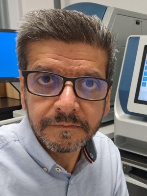 Headshot of Suki Klair wearing glasses