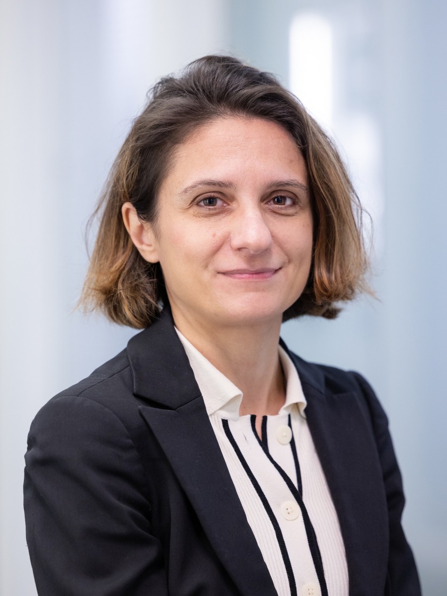 Headshot of Cecilia Mattevi smiling to camera in navy suit jacket and white shirt