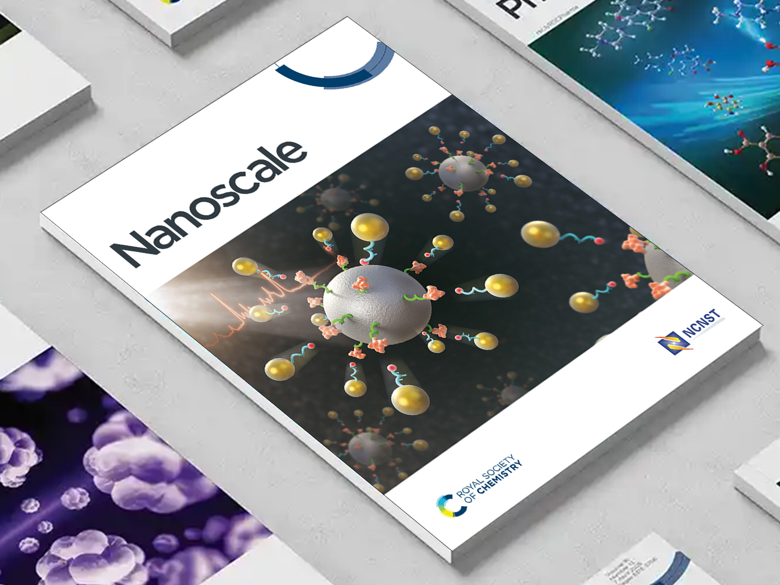 the Nanoscale journal among a group of other journals on a desk