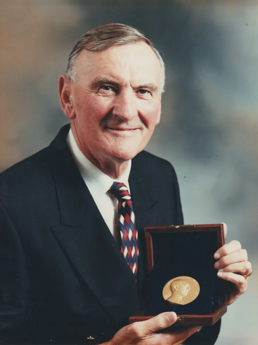 John William Lewis - deceased John Lewis in suit and tie holding award medal