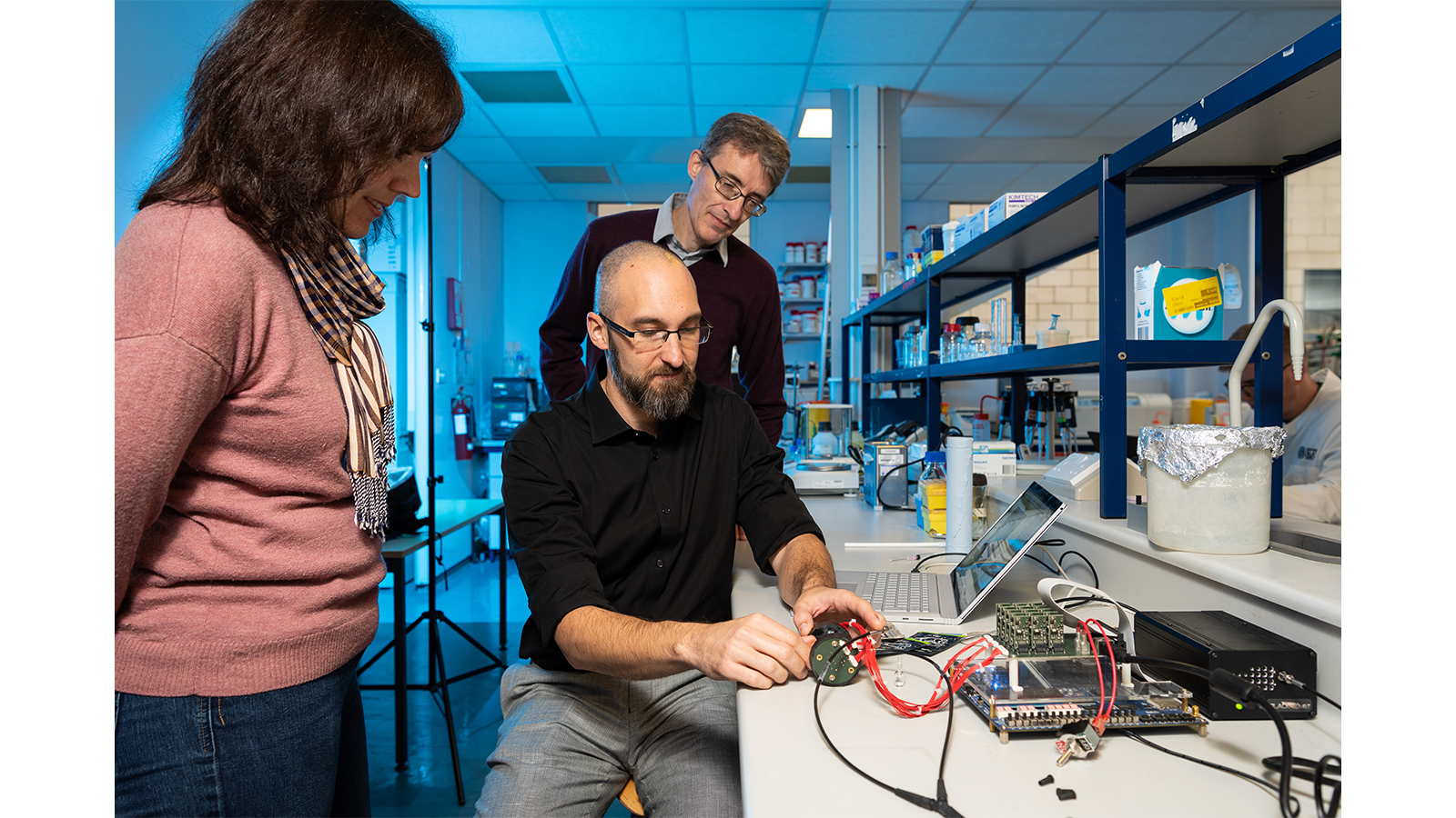 Harm Reduction standing with their equipment in a lab