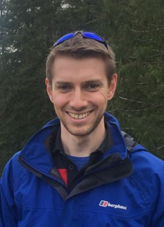 a man wearing a blue jacket and sunglasses