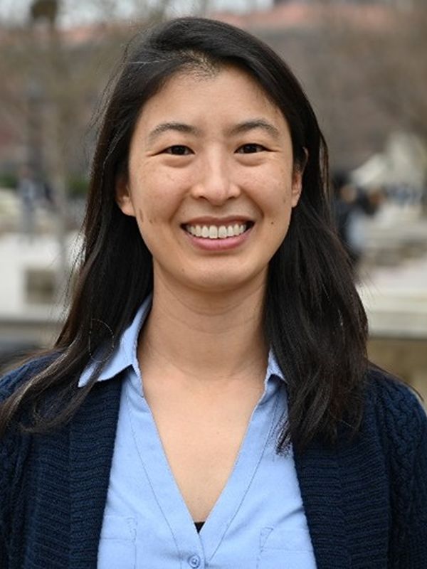 Christina Li headshot, smiling to camera in blue shirt and with long black hair