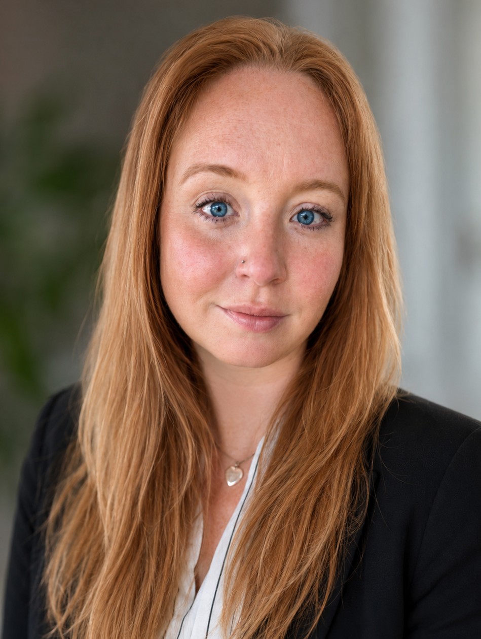 Headshot of Rebecca Garton smiling at the camera, wearing a black blazer.
